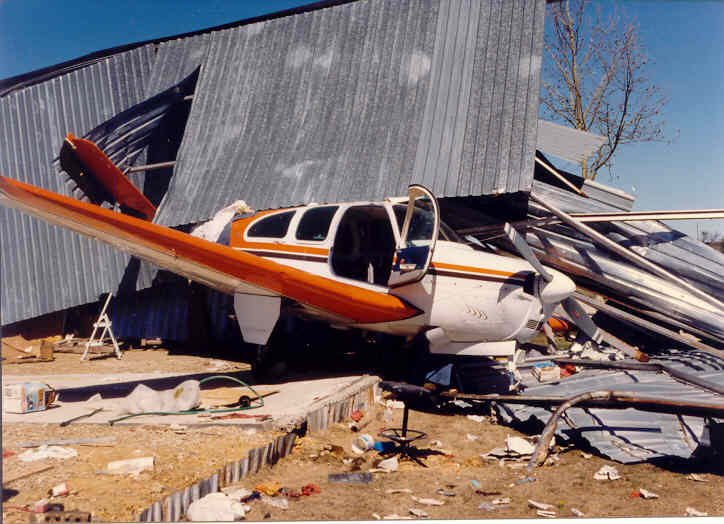 storm damage to hangar and plane